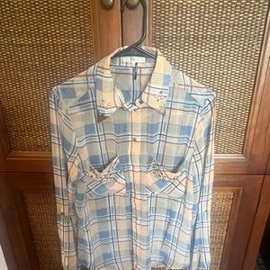 Beautiful long sleeve sheer top with Gold emblem on collar and gems on pockets